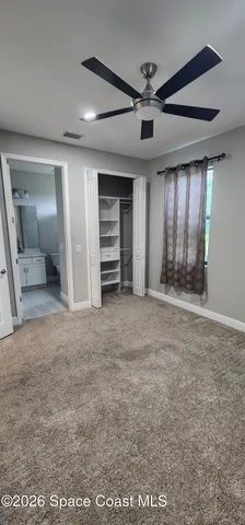 a white toilet sitting next to a bath tub and shower