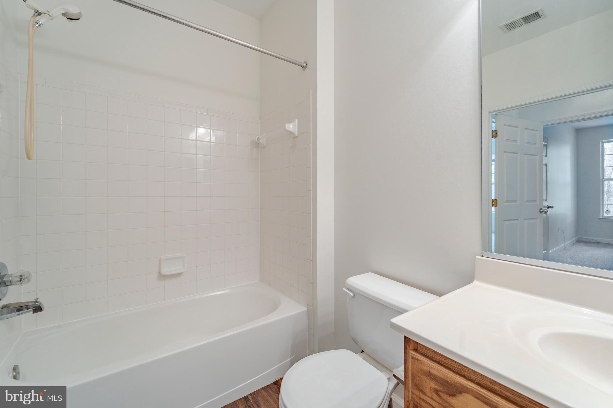 8611 Willow Leaf Lane Odenton, MD 21113 - Photo 22 of 33 a bathroom with a sink a toilet and shower