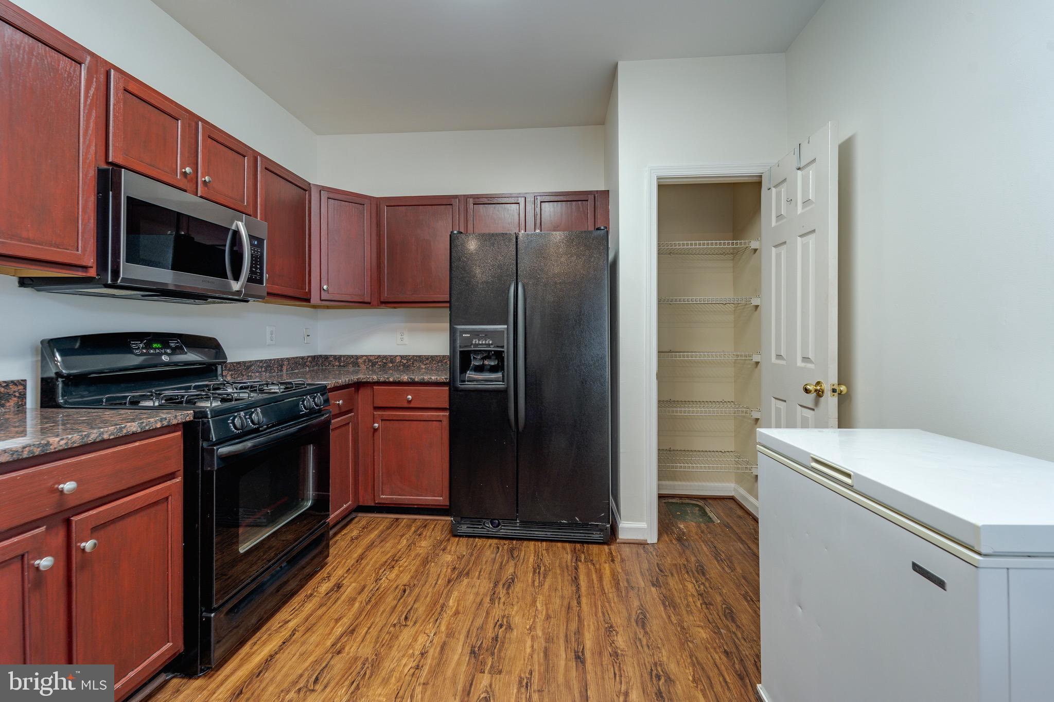 8611 Willow Leaf Lane Odenton, MD 21113 - Photo 10 of 33 a kitchen with stainless steel appliances granite countertop a refrigerator stove and sink