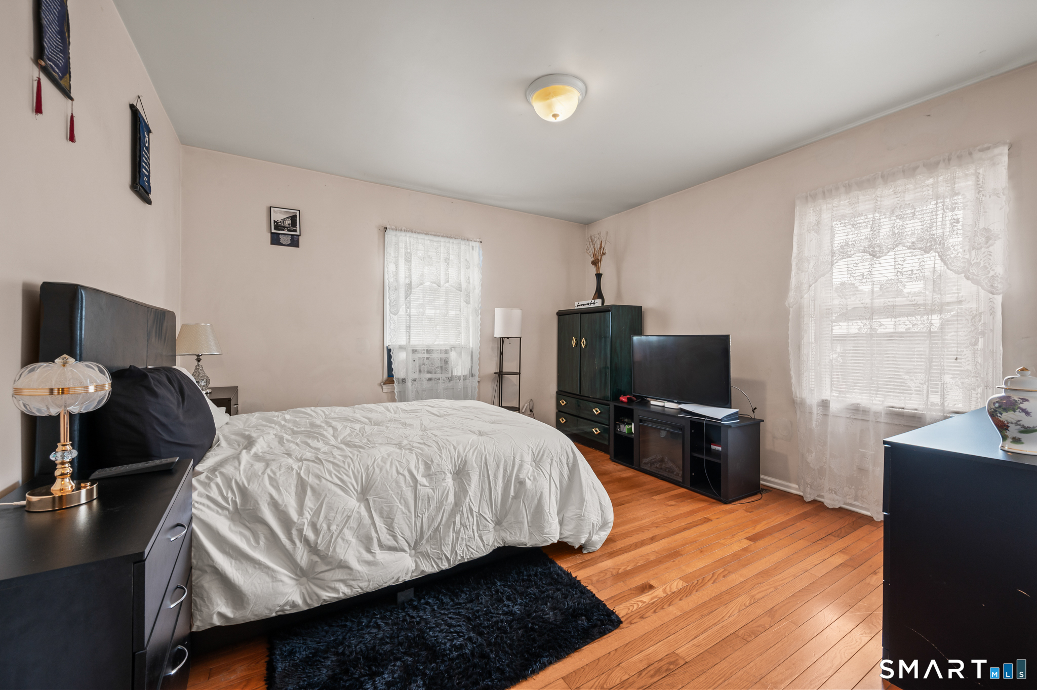 85 Dwight Street Ansonia, CT 06401 - Photo 15 of 40 a bedroom with a bed and wooden floor