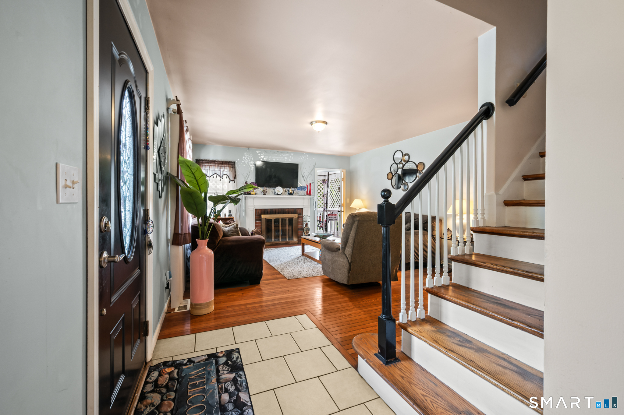 85 Dwight Street Ansonia, CT 06401 - Photo 2 of 40 a living room with furniture and a fireplace