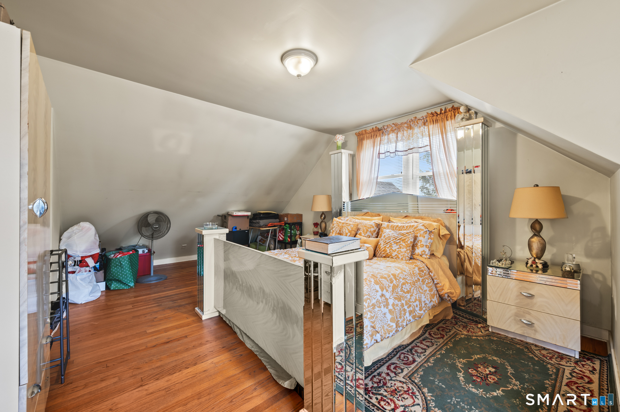 85 Dwight Street Ansonia, CT 06401 - Photo 21 of 40 a bed room with a bed and a chandelier