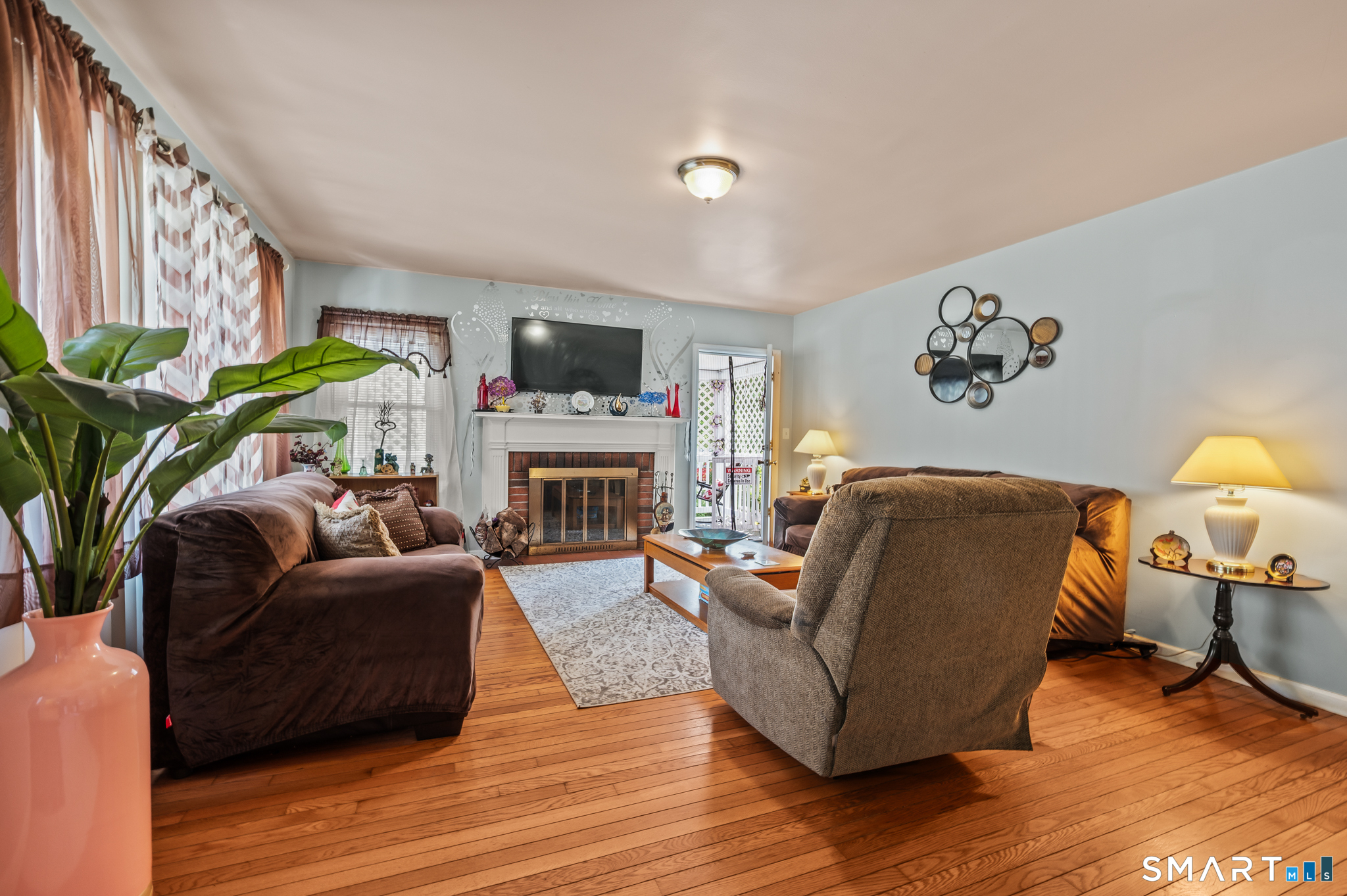 85 Dwight Street Ansonia, CT 06401 - Photo 5 of 40 a living room with furniture a fireplace and a flat screen tv