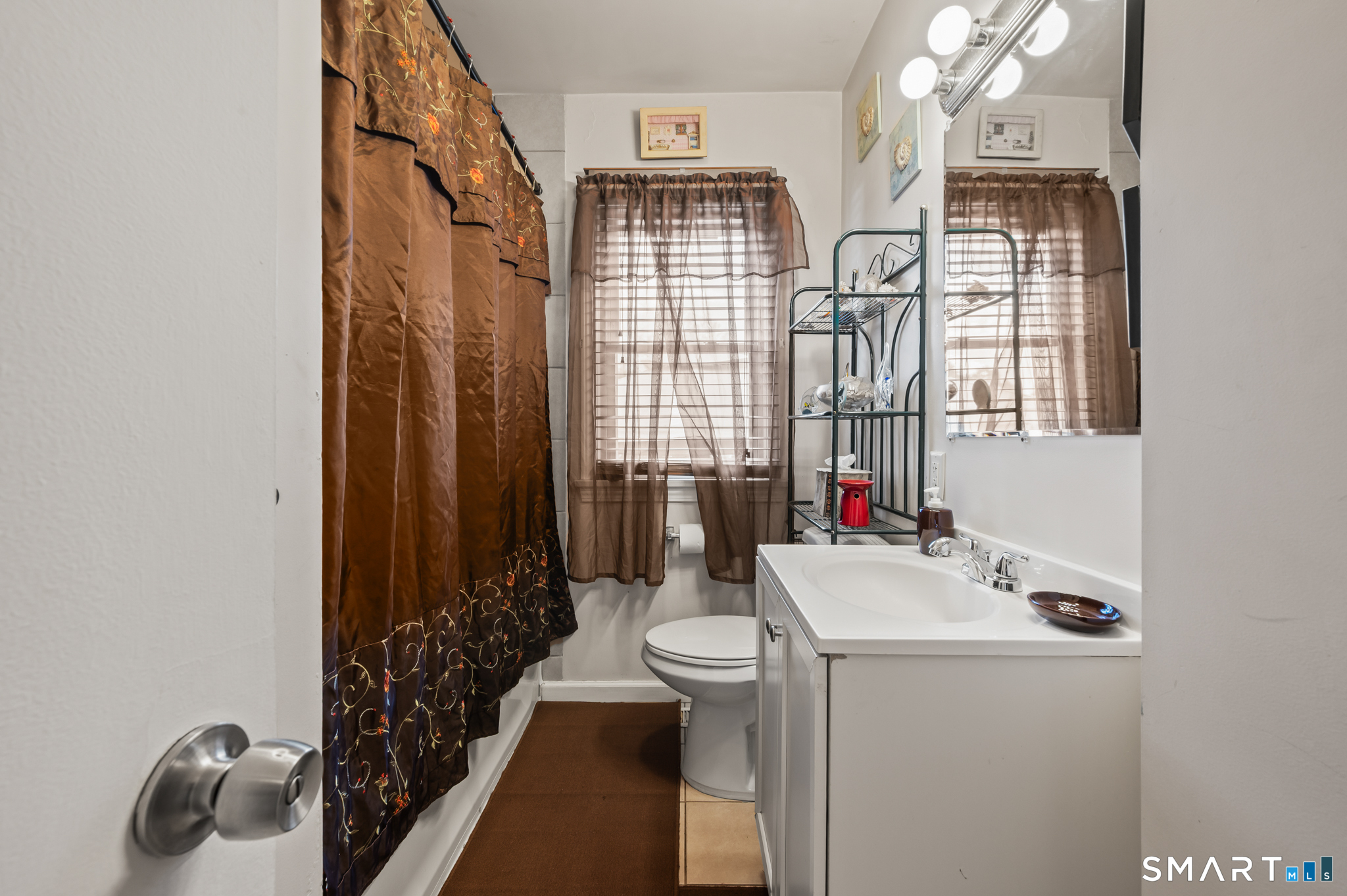 85 Dwight Street Ansonia, CT 06401 - Photo 7 of 40 a bathroom with a sink a toilet and shower curtain