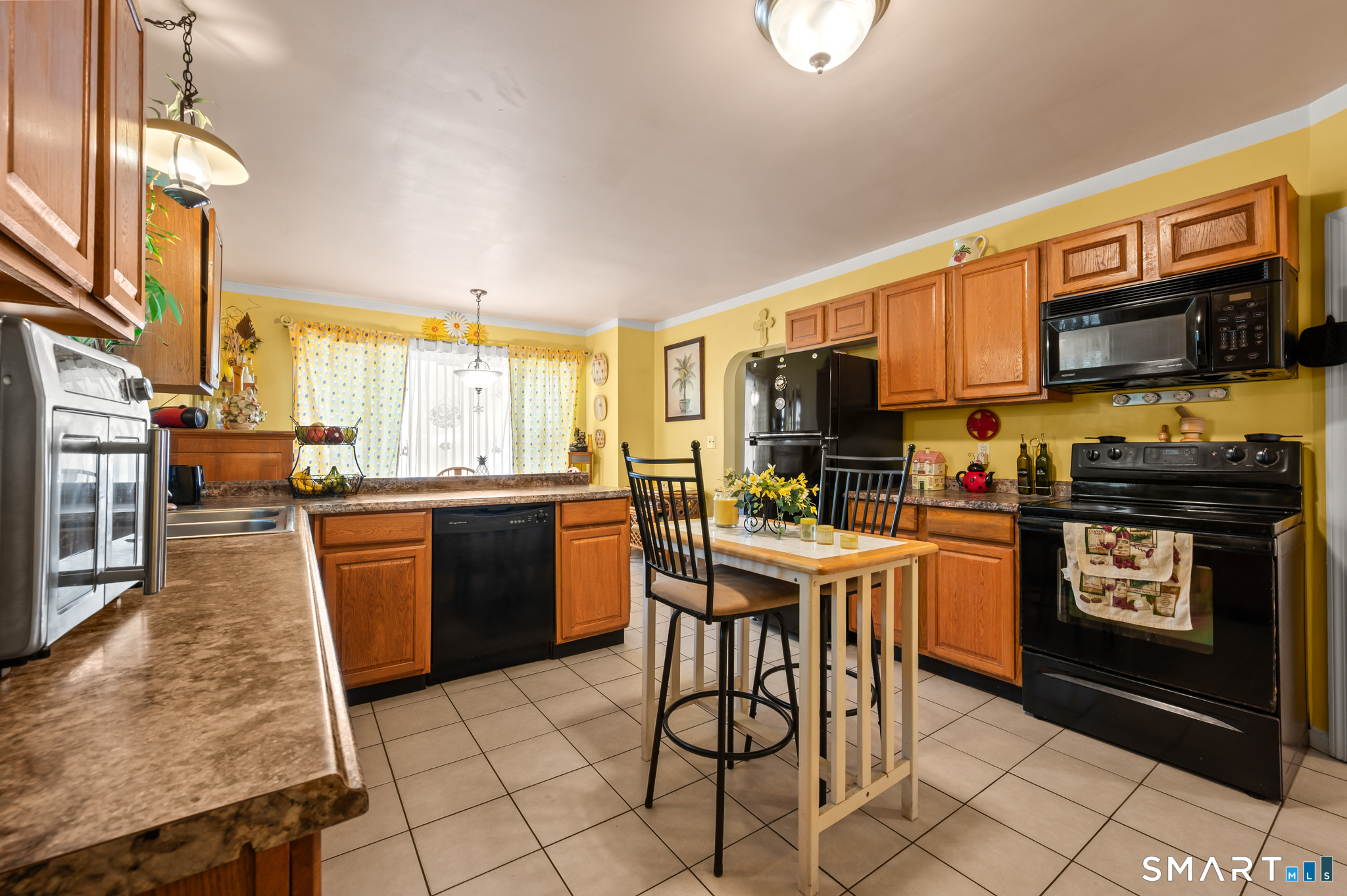 85 Dwight Street Ansonia, CT 06401 - Photo 8 of 40 a kitchen with stainless steel appliances granite countertop a refrigerator a stove top oven a sink dishwasher and wooden cabinets
