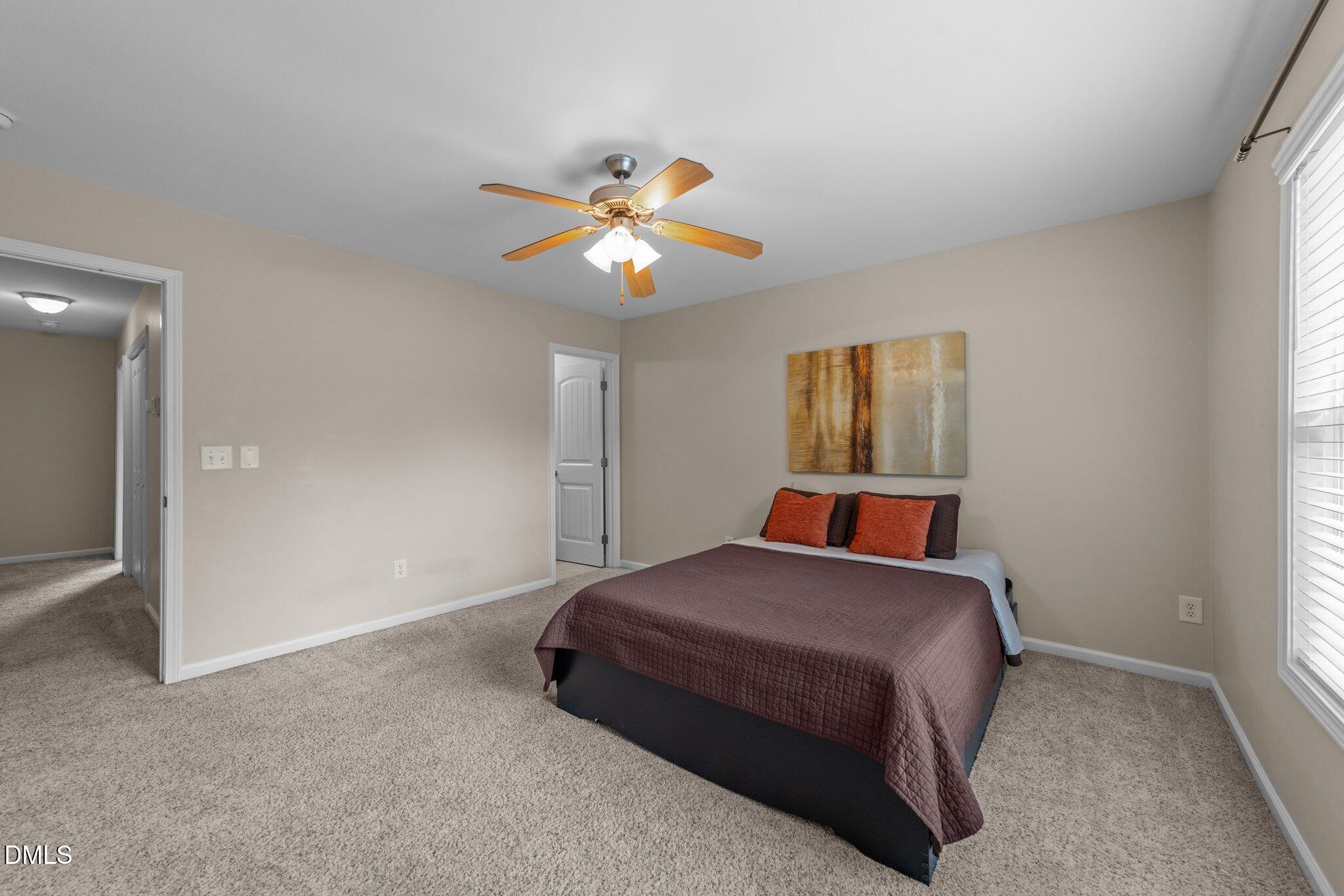 158 Pineland Circle Raleigh, NC 27606 - Photo 13 of 34 a bedroom with a bed and a chandelier