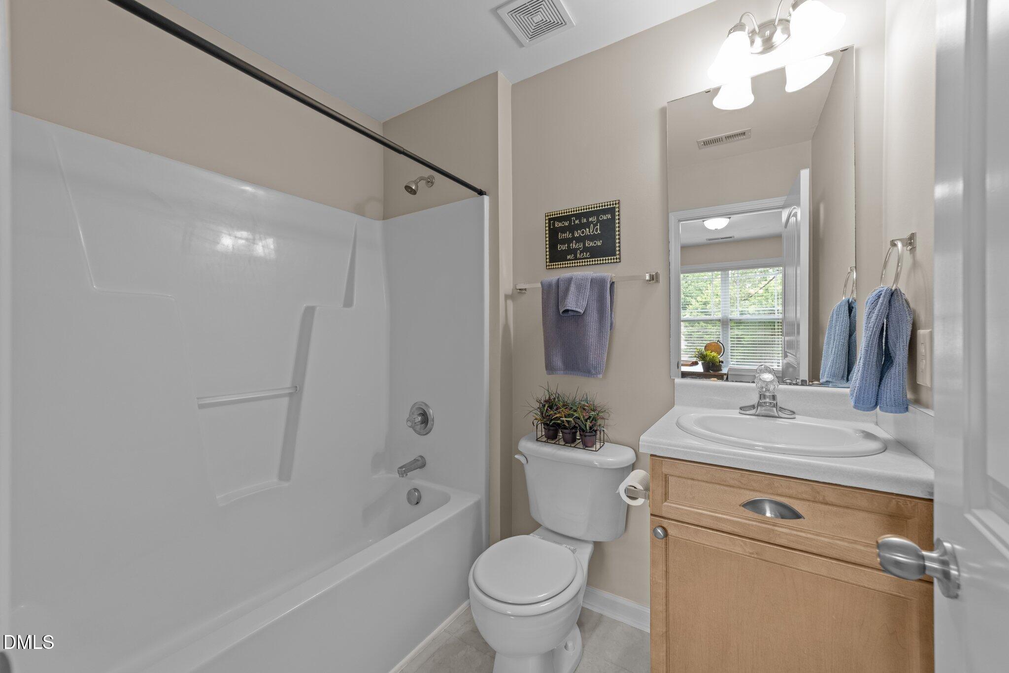158 Pineland Circle Raleigh, NC 27606 - Photo 20 of 34 a bathroom with a sink a toilet a mirror and shower