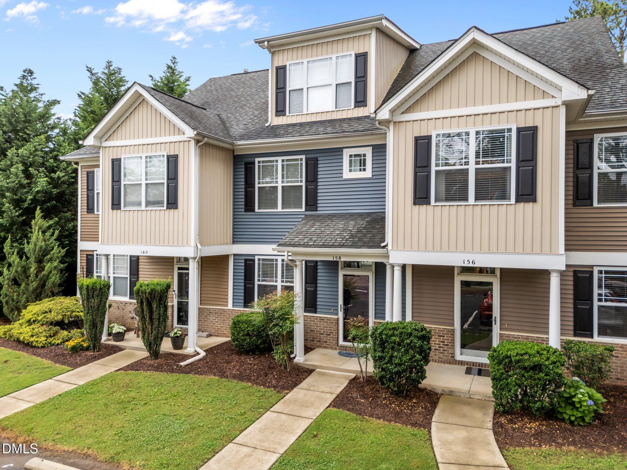 158 Pineland Circle Raleigh, NC 27606 - Photo 3 of 34 a front view of a house with yard and green space