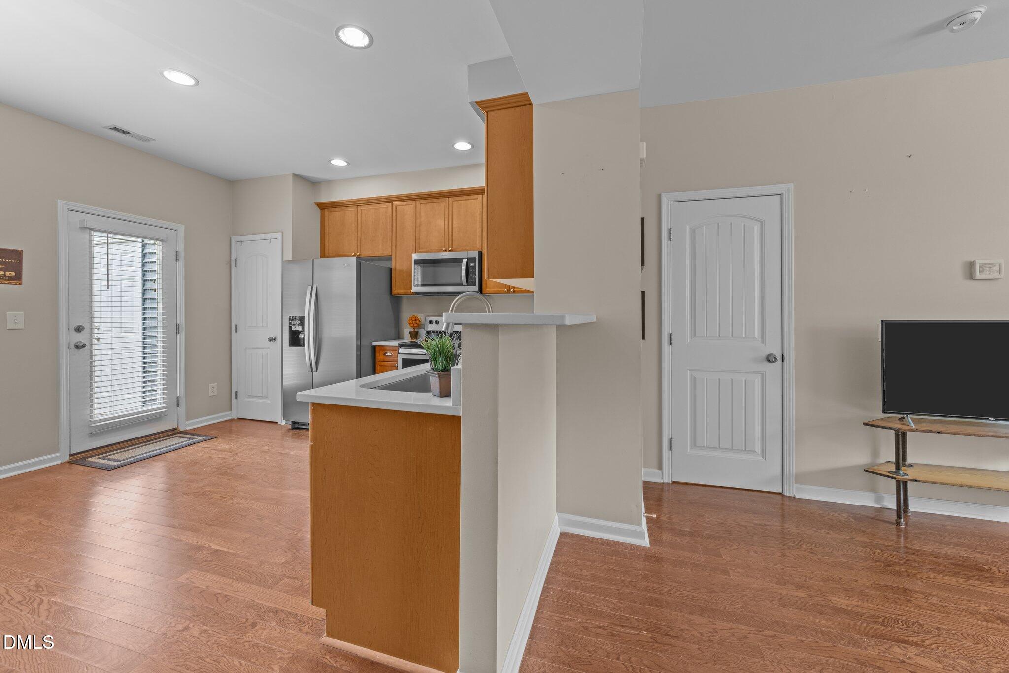 158 Pineland Circle Raleigh, NC 27606 - Photo 7 of 34 a view of kitchen with stainless steel appliances cabinets and wooden floor
