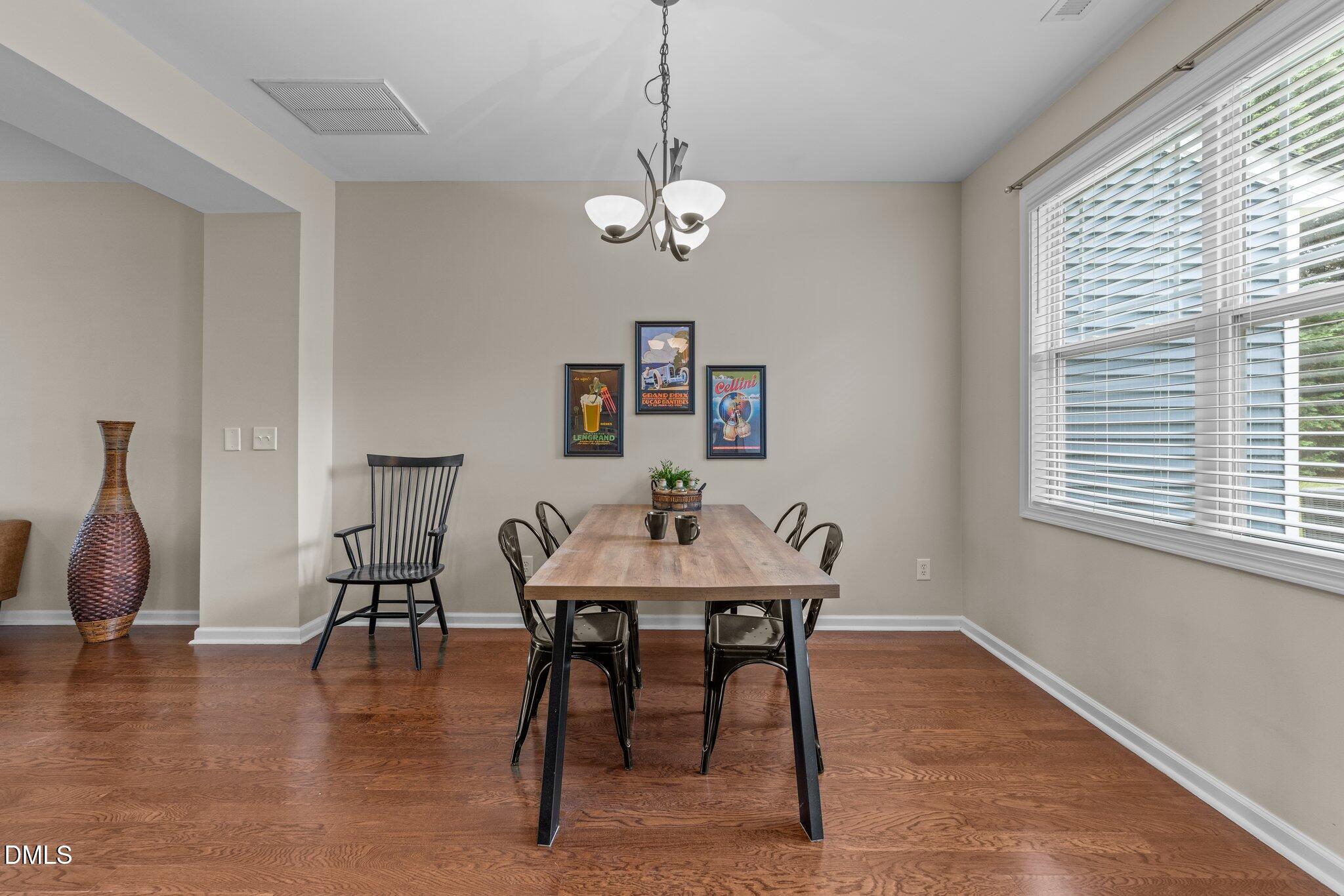 158 Pineland Circle Raleigh, NC 27606 - Photo 8 of 34 a view of a dining room with furniture window and wooden floor