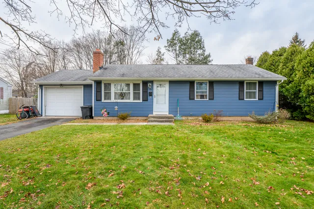a front view of a house with a yard