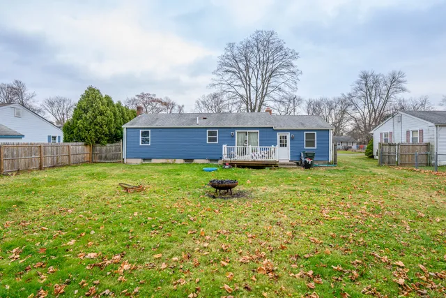 a front view of a house with yard and green space