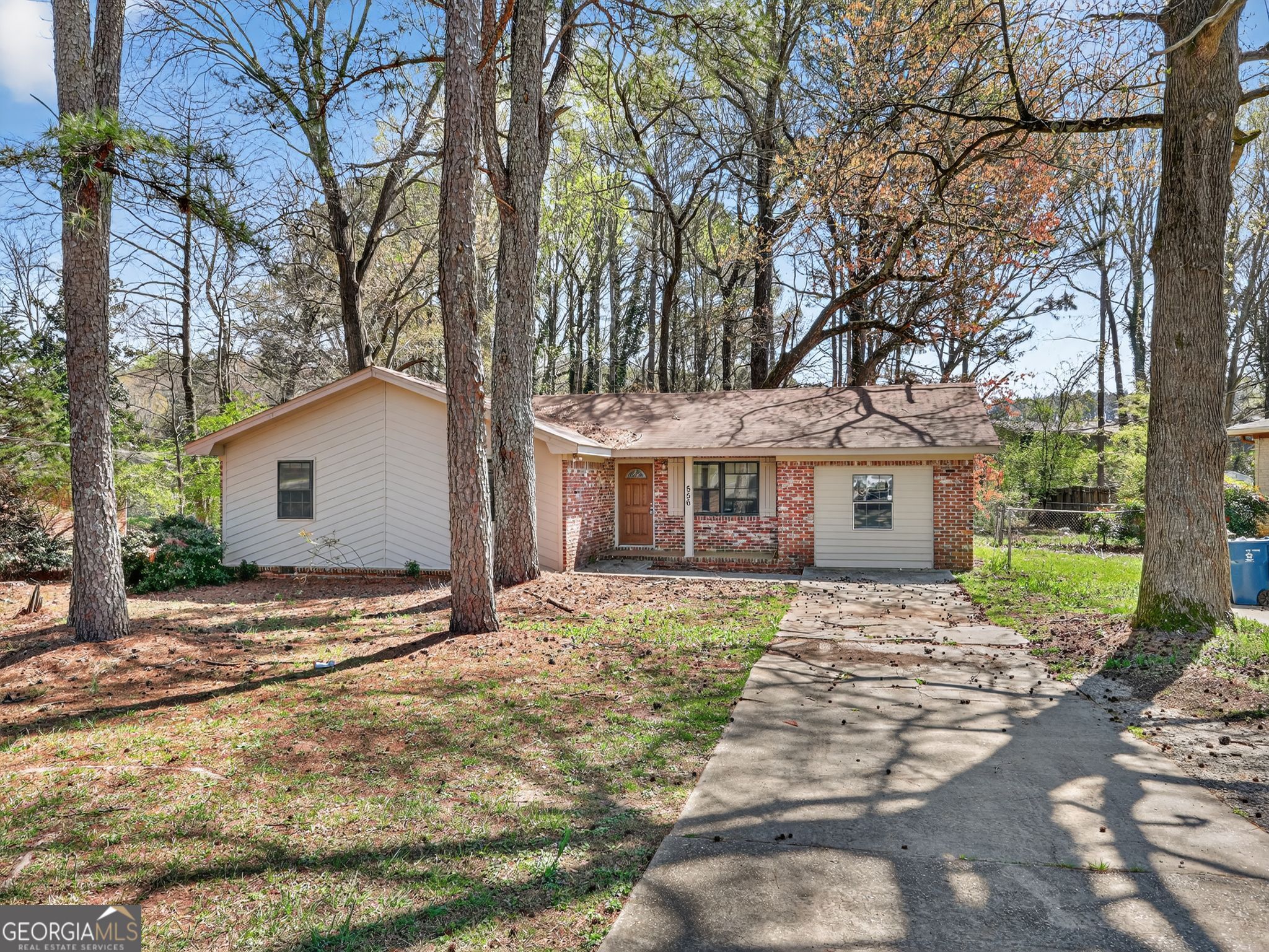 556 Roy Huie Road Riverdale, GA 30274 - Photo 1 of 31 a front view of a house with a garden and trees
