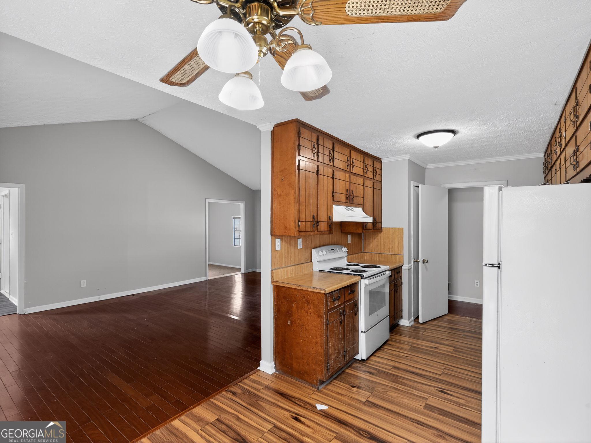 556 Roy Huie Road Riverdale, GA 30274 - Photo 12 of 31 a kitchen with a stove cabinets and wooden floor
