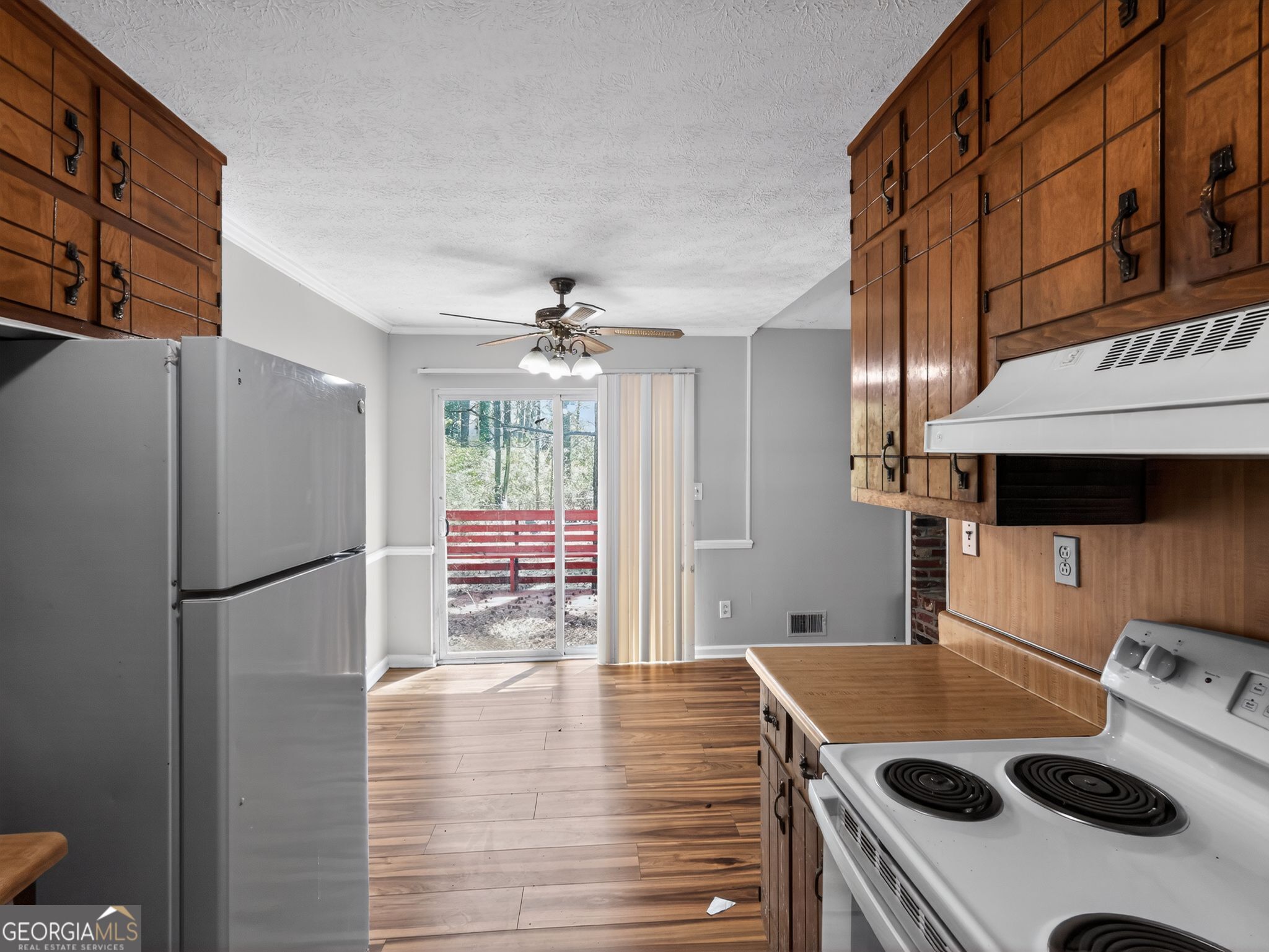 556 Roy Huie Road Riverdale, GA 30274 - Photo 14 of 31 a kitchen with a refrigerator a stove a sink and a cabinets