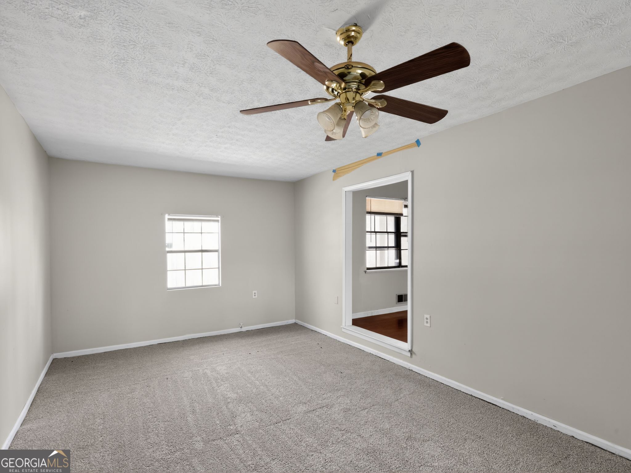 556 Roy Huie Road Riverdale, GA 30274 - Photo 18 of 31 an empty room with windows and fan