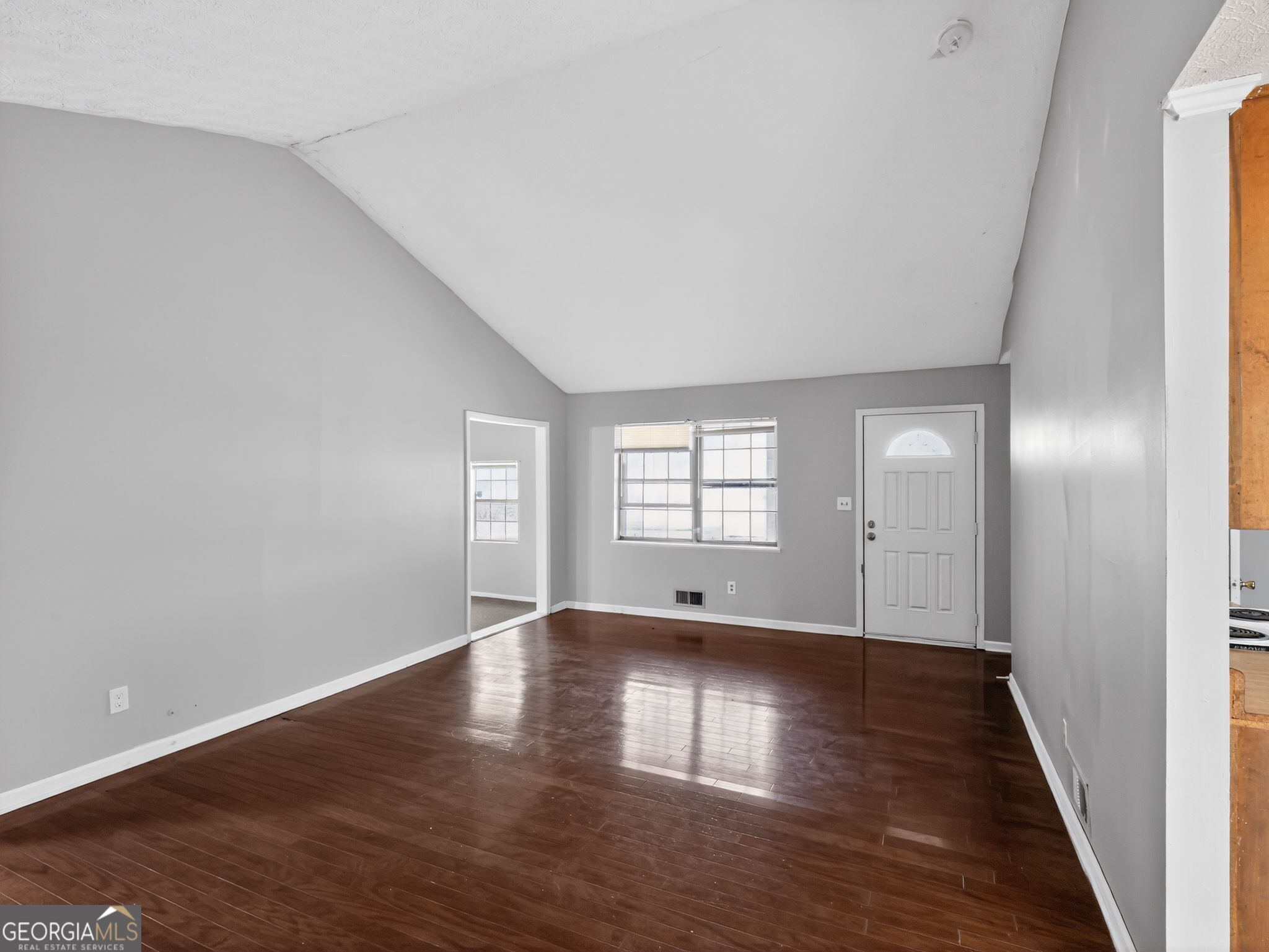 556 Roy Huie Road Riverdale, GA 30274 - Photo 2 of 31 a view of an empty room with window and wooden floor