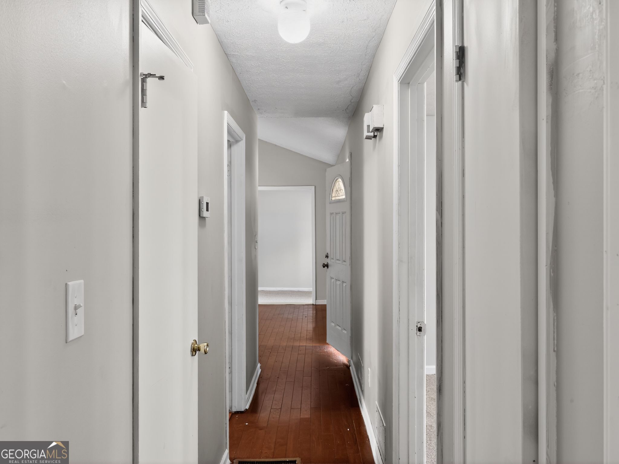 556 Roy Huie Road Riverdale, GA 30274 - Photo 27 of 31 a view of a hallway with closet and wooden floor