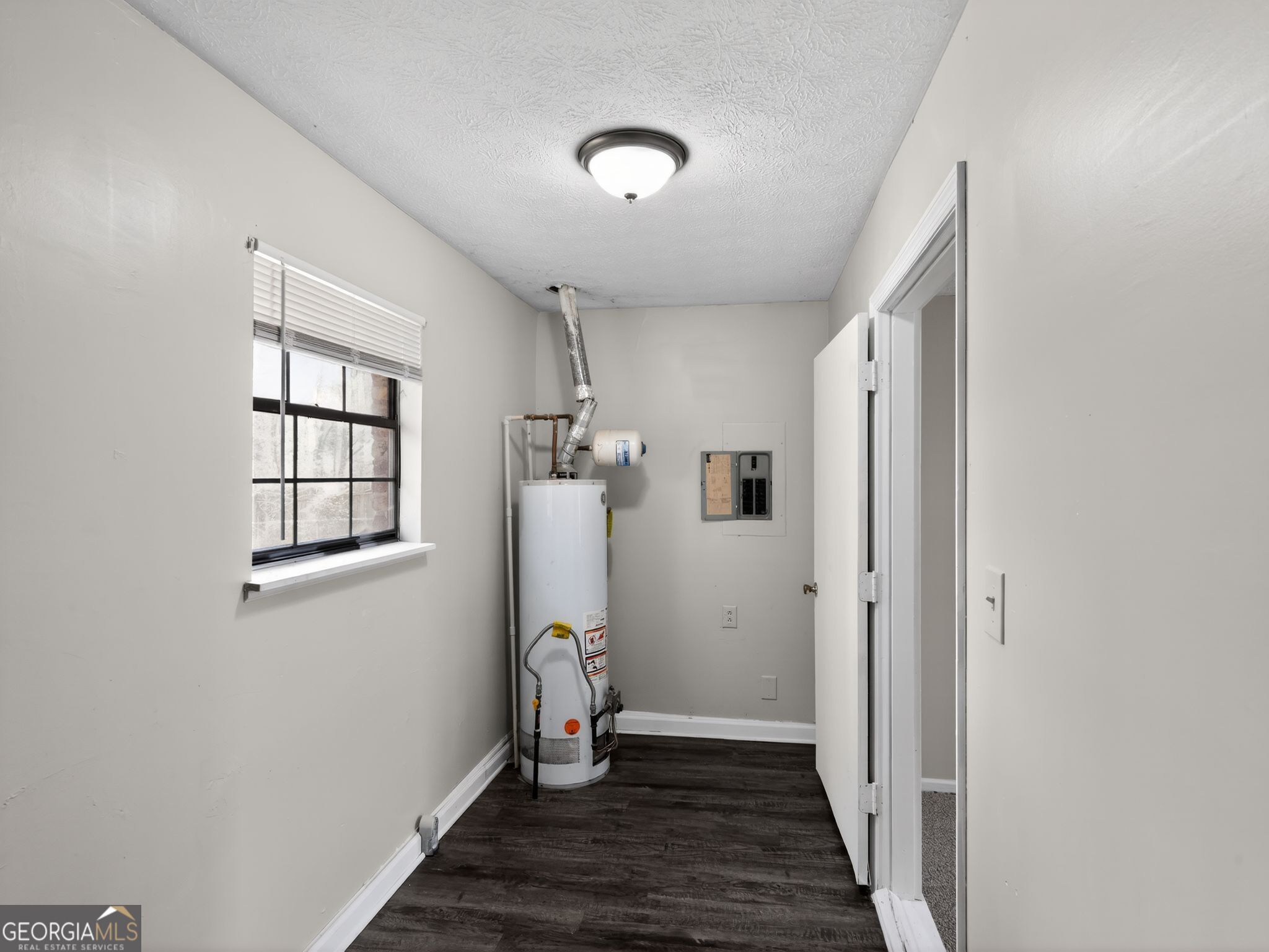 556 Roy Huie Road Riverdale, GA 30274 - Photo 28 of 31 a view of hallway with window and wooden floor