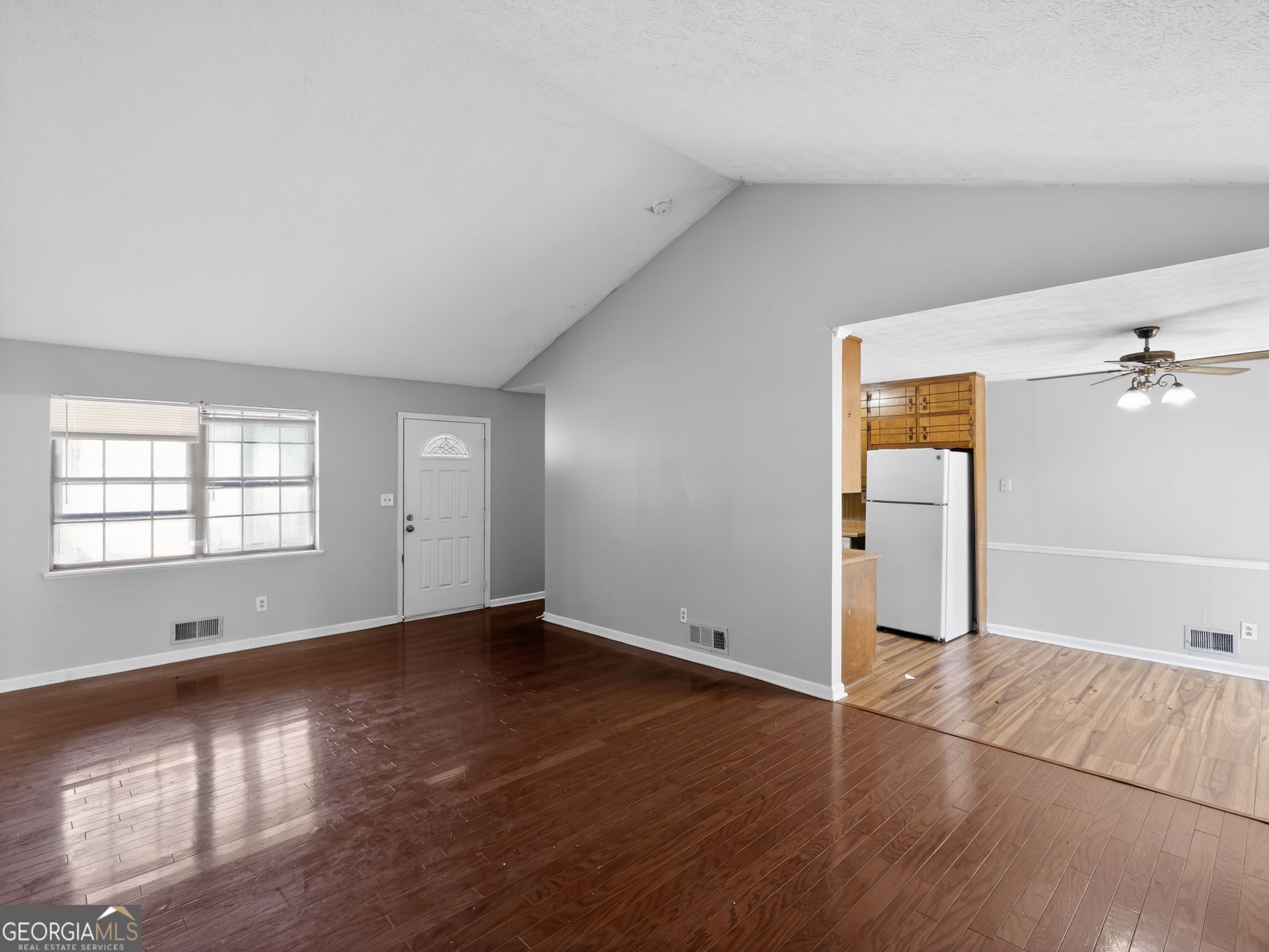 556 Roy Huie Road Riverdale, GA 30274 - Photo 6 of 31 an empty room with wooden floor and windows