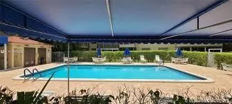 a room with wooden cabinets and white appliances