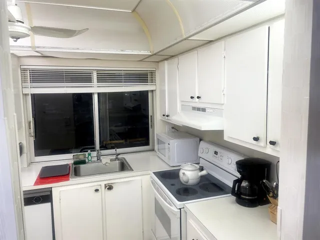 a kitchen with a sink and white cabinets