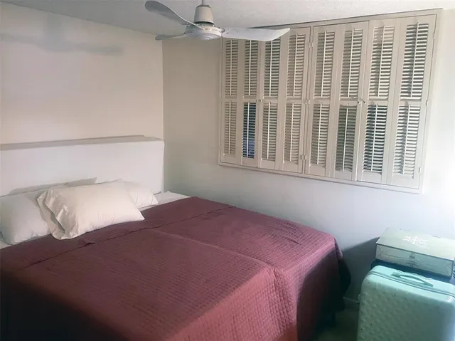 a bedroom with bed and a window