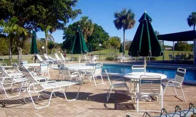 a view of outdoor kitchen with dining table and chairs
