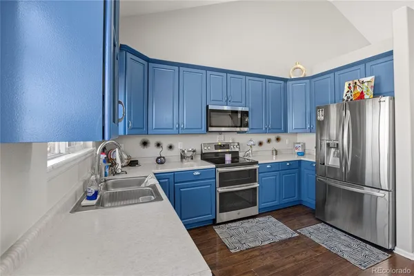 a kitchen with stainless steel appliances granite countertop a refrigerator stove and oven