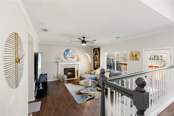 a living room with furniture fireplace and a large window