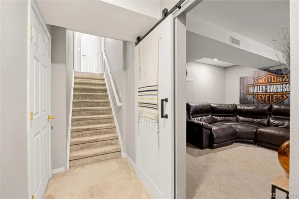 a living room with furniture and a stairs