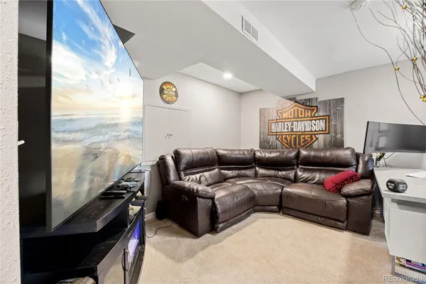 a living room with furniture and a floor to ceiling window