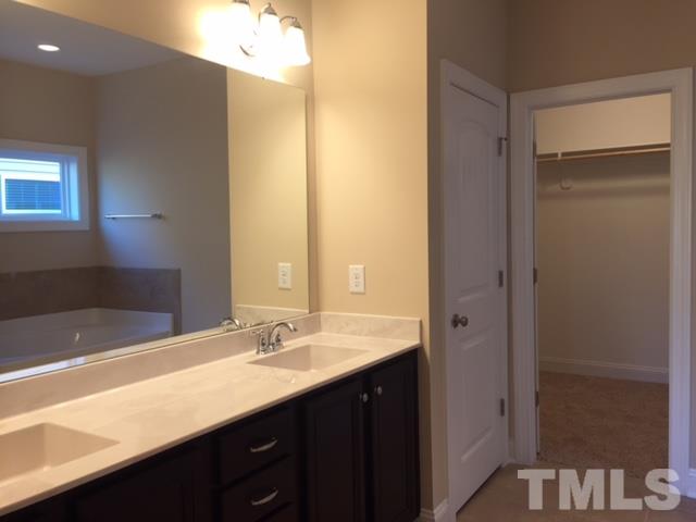 2016 Temple Hills Way Fuquay-Varina, NC 27526 - Photo 11 of 13 a bathroom with a sink and a mirror
