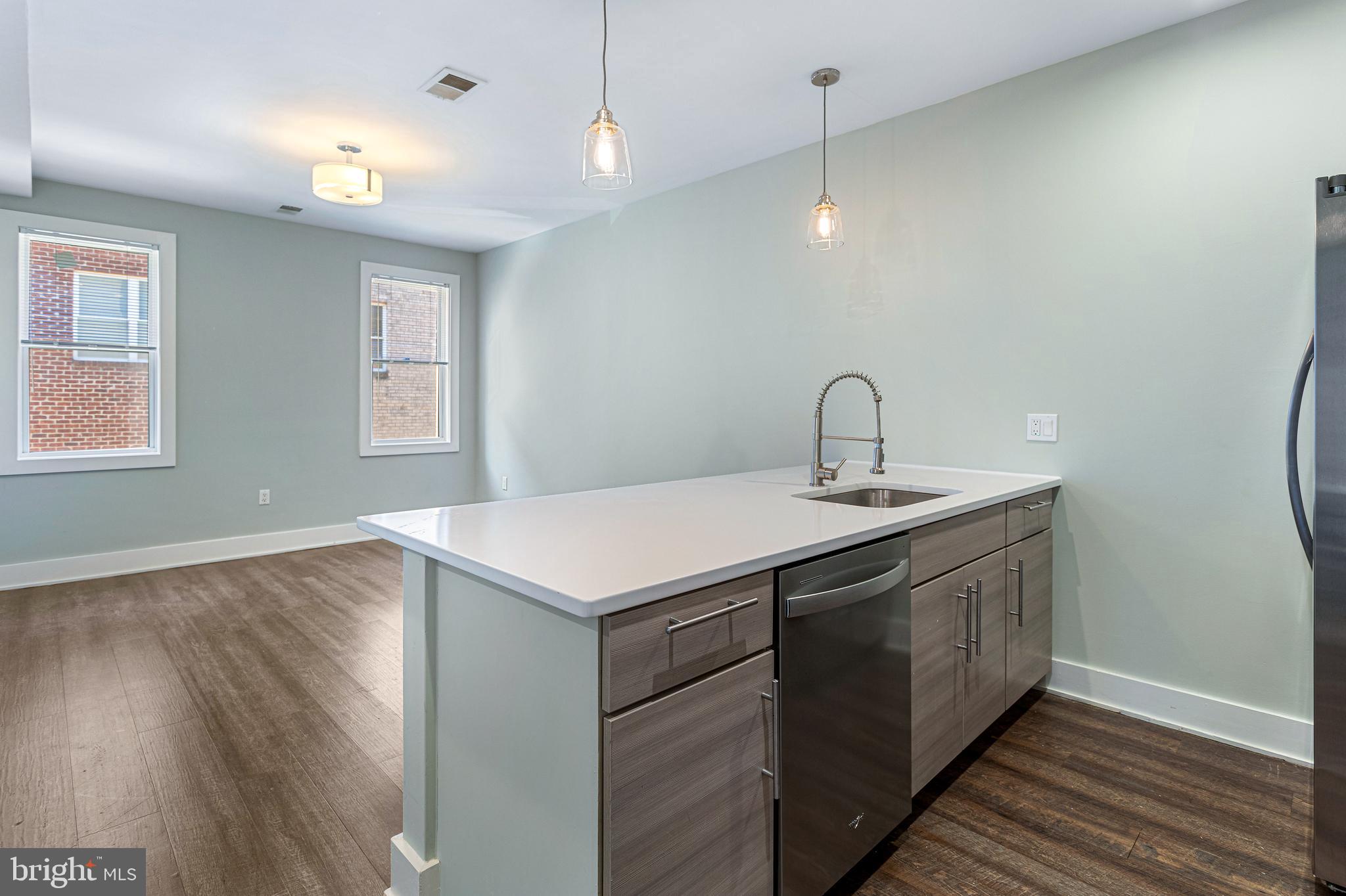 1219 K Street Northeast, Unit 202 Washington, DC 20002 - Photo 4 of 15 a kitchen with a sink and wooden floor