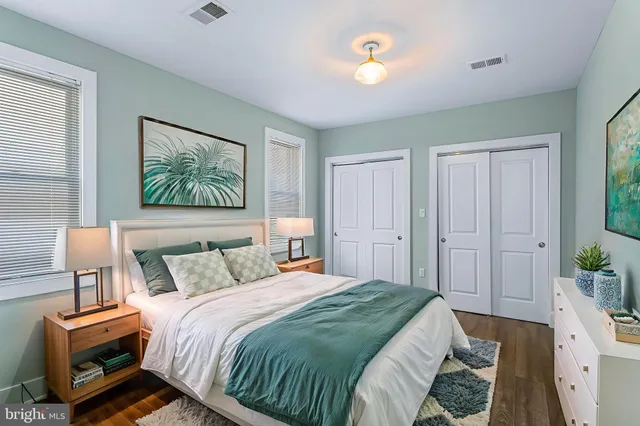 a bedroom with a bed and a lamp