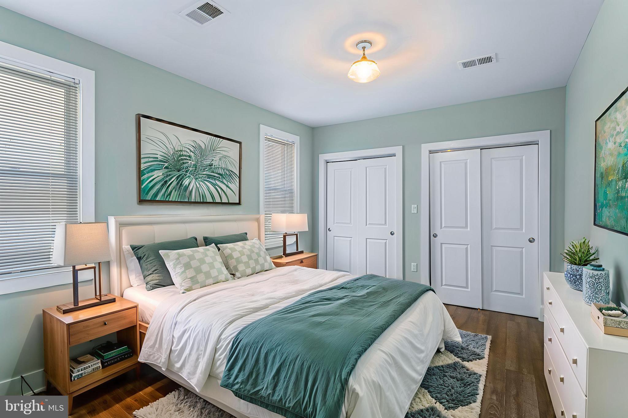 1219 K Street Northeast, Unit 202 Washington, DC 20002 - Photo 8 of 15 a bedroom with a bed and a lamp