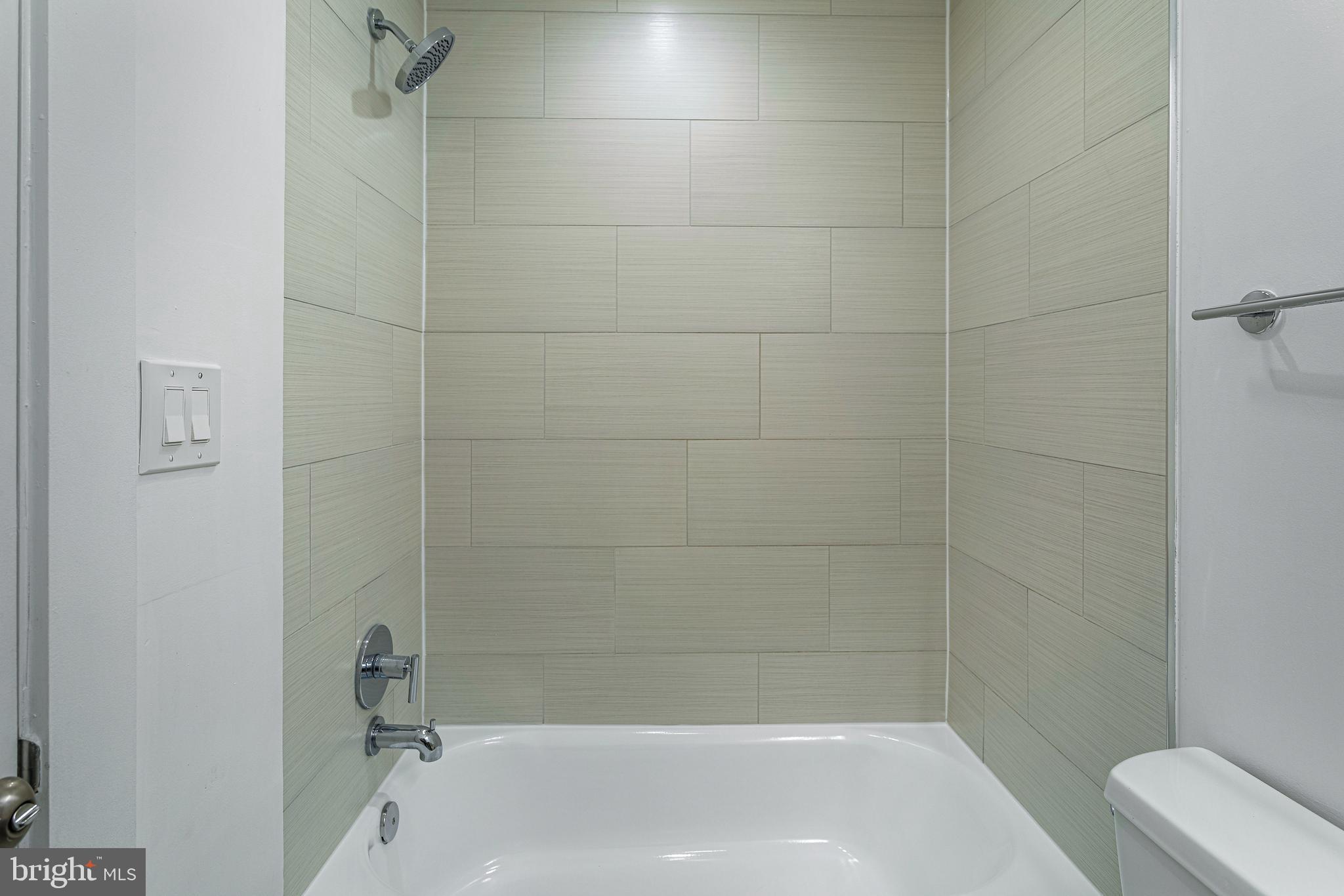 1219 K Street Northeast, Unit 202 Washington, DC 20002 - Photo 10 of 15 a bathroom with a shower and bathtub