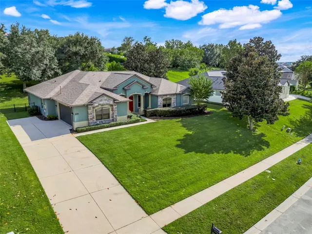 a aerial view of a house with swimming pool and a yard