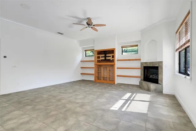 a view of a room with cabinet a flat screen tv and windows