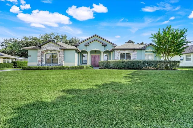 a view of a house with a big yard and potted plants