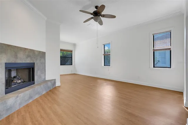 a view of an empty room with a fireplace and a window