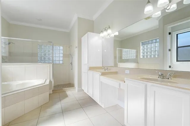 a bathroom with a granite countertop sink a toilet a mirror and bathtub