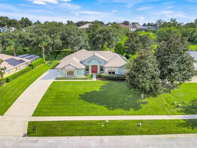 a view of a garden with a house in the background