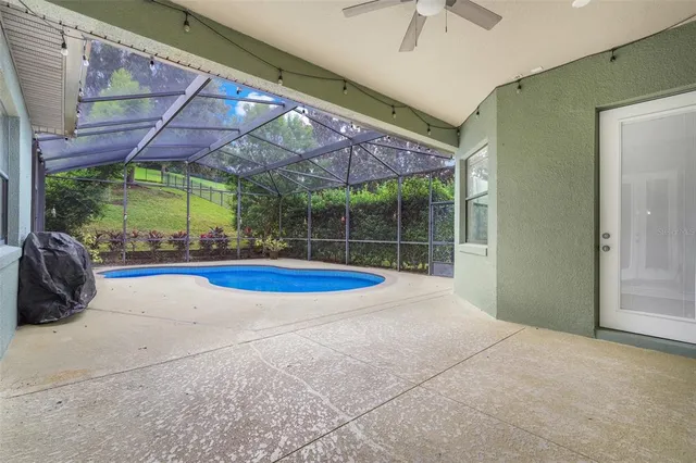 a view of a backyard patio with swimming pool