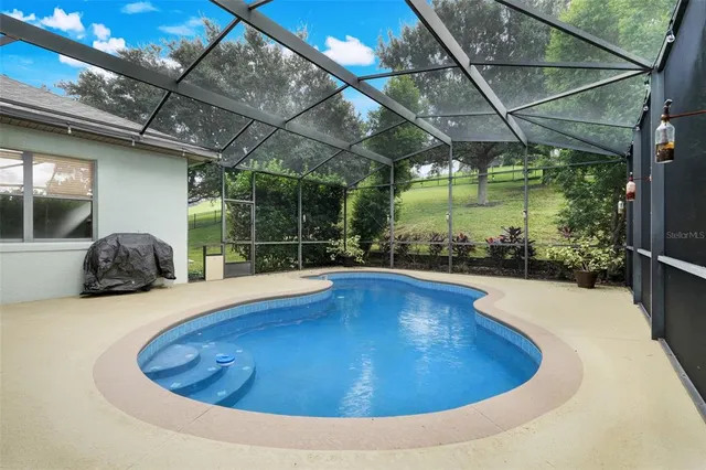 a view of swimming pool with outdoor seating