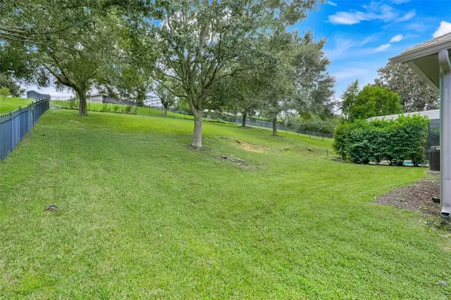 a view of a couches in a patio with a yard