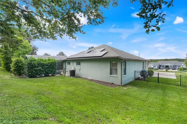 a green field with lots of trees