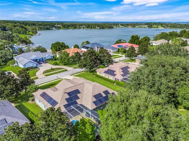an aerial view of multiple houses with yard