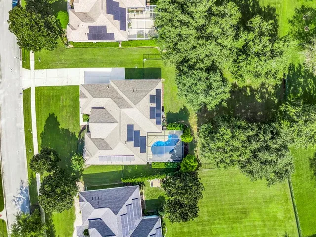 an aerial view of a house with a garden and trees