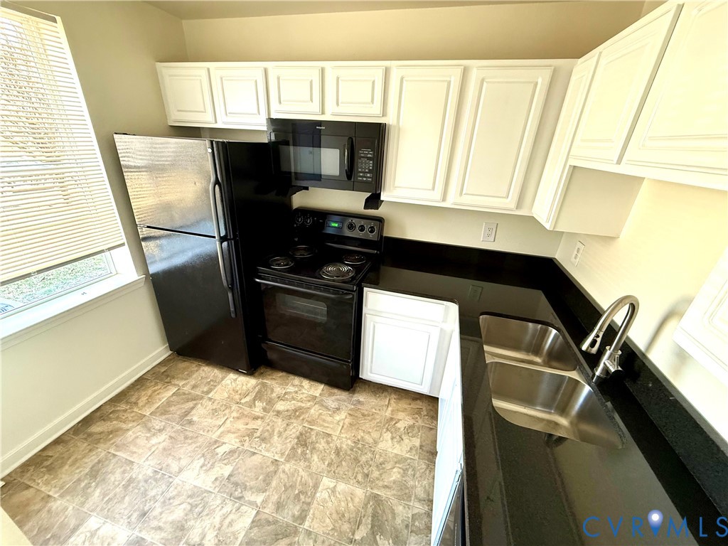 3510 East Richmond Road, Unit U12 Richmond, VA 23223 - Photo 2 of 26 a kitchen with a sink a stove and a microwave
